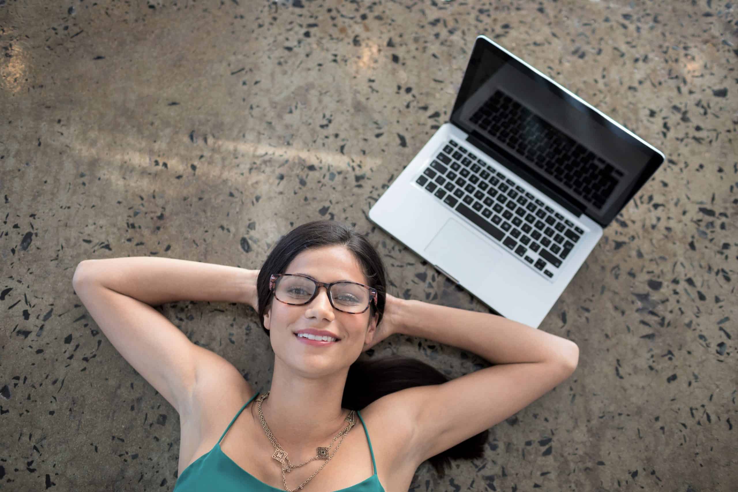 Portrait of female executive lying on the floor
